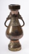A Chinese bronze two-handled vase in archaic style of baluster form cast with bands of taotie masks