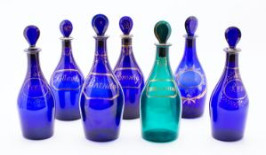 A group of seven Bristol blue and green decanters with mushroom stoppers comprising two pairs with