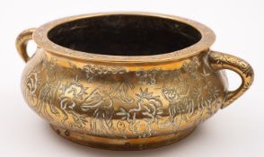 A Chinese polished bronze censer of compressed form with loop handles,