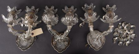 A set of three moulded and cut glass twin light wall appliques,
