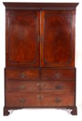 A George III mahogany linen press, circa 1800; with moulded cornice and fluted frieze,