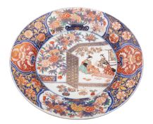 A Japanese Imari charger painted with three bijin, one playing a koto,