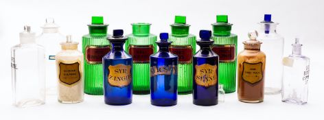 A group of thirteen glass apothecary bottles, of clear,