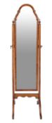 A walnut framed cheval mirror in Queen Anne taste, 20th century; with cusped arched top,