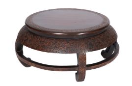A Chinese carved and stained hardwood stand, early 20th century; of circular form,