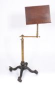A Victorian cast iron and brass reading or music stand, circa 1870; fully adjustable in angle,
