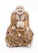 A Japanese Satsuma figure of Hotei,