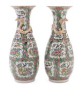 A pair of Canton porcelain vases of slender oviform with raised flaring neck,