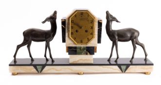 A French Art Deco marble mantel clock with opposing figures of deer,