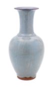 A Chinese pottery vase of oviform with raised slender neck and under a pale blue glaze with
