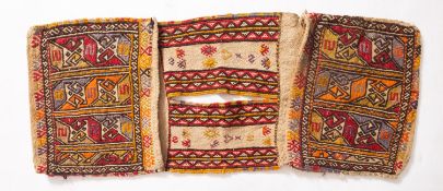 A Turkish saddle bag, the twin faces with hooked and geometric designs with banded centre,