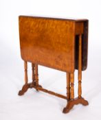 A Victorian birdseye maple Sutherland table, third quarter 19th century; with twin drop leaves,