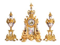 A gilt metal & porcelain clock garniture the eight-day duration movement striking the hours and