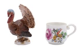 A Meissen model of a cock turkey and a Meissen custard cup the turkey with tail plumage displayed,