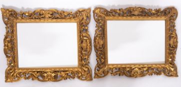 A pair of carved and giltwood framed rectangular wall mirrors, in Florentine 18th century style,