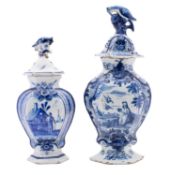 Two Dutch delft vases and covers,
