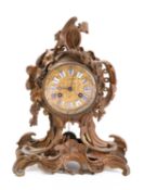 A Rococo revival gilt-metal mantel clock the eight-day duration movement striking the hours and