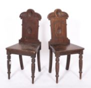 A pair of Victorian oak hall chairs,