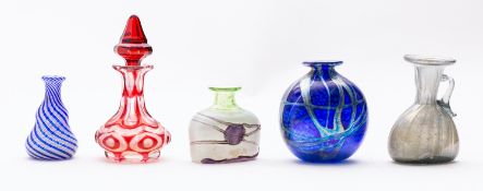 A group of five small glass vases and bottles including a ribbed pale green iridescent bottle with