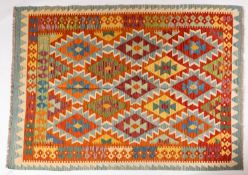 An Anatolian Turkish kelim, the brightly coloured field with serrated and lozenge medallions,