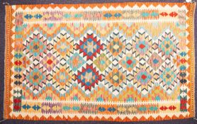 A Turkish rug, the triple field with a central zig-zag band and all over stellar medallions,