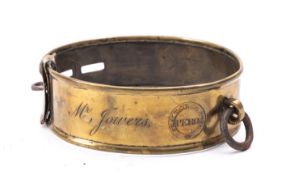An early 19th Century brass dog collar with rolled rim, ring attachment and three adjustment slots,