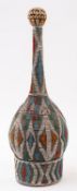 A Bamileke calabash wine bottle, Cameroon, 20th century; of long necked onion form,