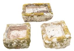 Three rough hewn granite troughs or planters,