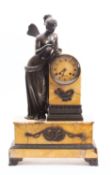 A bronze and cream marble clock the eight-day duration movement striking the hours and half-hours