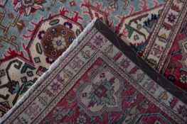 A Heriz carpet, the pastel blue field with a central rose geometric pole medallion,