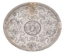 A Chinese charger decorated in black monochrome with panels of dragons and phoenix on a floral