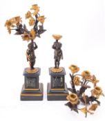 A pair of Continental patinated bronze, gilt metal and marble mounted four light figural candelabra,