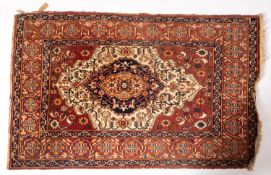 A Hamadan rug, the brown field with a central ivory cartouche panel and indigo pole medallion,
