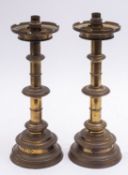 A pair of gilt brass altarsticks refitted as table lamps, in Mediaeval Gothic taste,