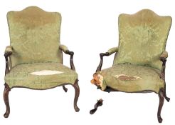 A pair of mahogany and upholstered open armchairs in Chippendale style,