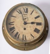 A brass bulkhead clock, maker Health and Co, London,