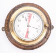 A brass and oak Radio Room bulkhead clock,
