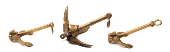 Three brass models of anchors, length of largest 20cm.