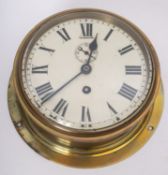 A WWII period circular brass bulkhead clock, maker W Elliott Ltd, London,
