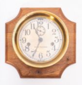 An American lacquered brass bulkhead clock, maker Seth Thomas,