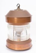 A circular copper ship's lamp, unsigned, later electrical conversion,32.5cm high.