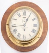 A brass bulkhead clock, maker Chadburn's, Liverpool,