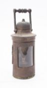 An early 20th century brass binnacle lantern, of cylindrical form with turned ebony handle,