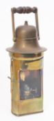 A brass binnacle lamp, unsigned, wooden turned swing handle over domed top and single glazed door,