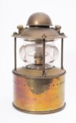 A circular brass toplght, unsigned, the domed cover with swing handle above,