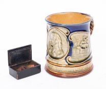 A 19th Century papier mache snuff box containing a carved erotic view, 5cm wide,