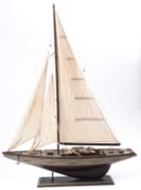 A scale model of a yacht, fully rigged over deck with fittings,
