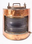 A copper and brass ship's lamp, unsigned, with single clear lens,