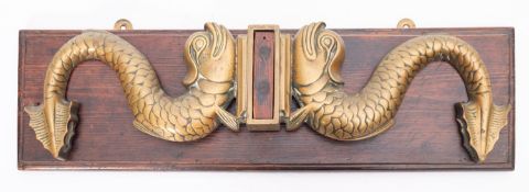An Admiralty pattern brass tiller yoke from the launch of HMS Repulse, mounted on a wooden plinth,