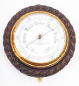 An Edwardian carved oak aneroid barometer for the 'Steam Drifters Stores Co, Ltd.